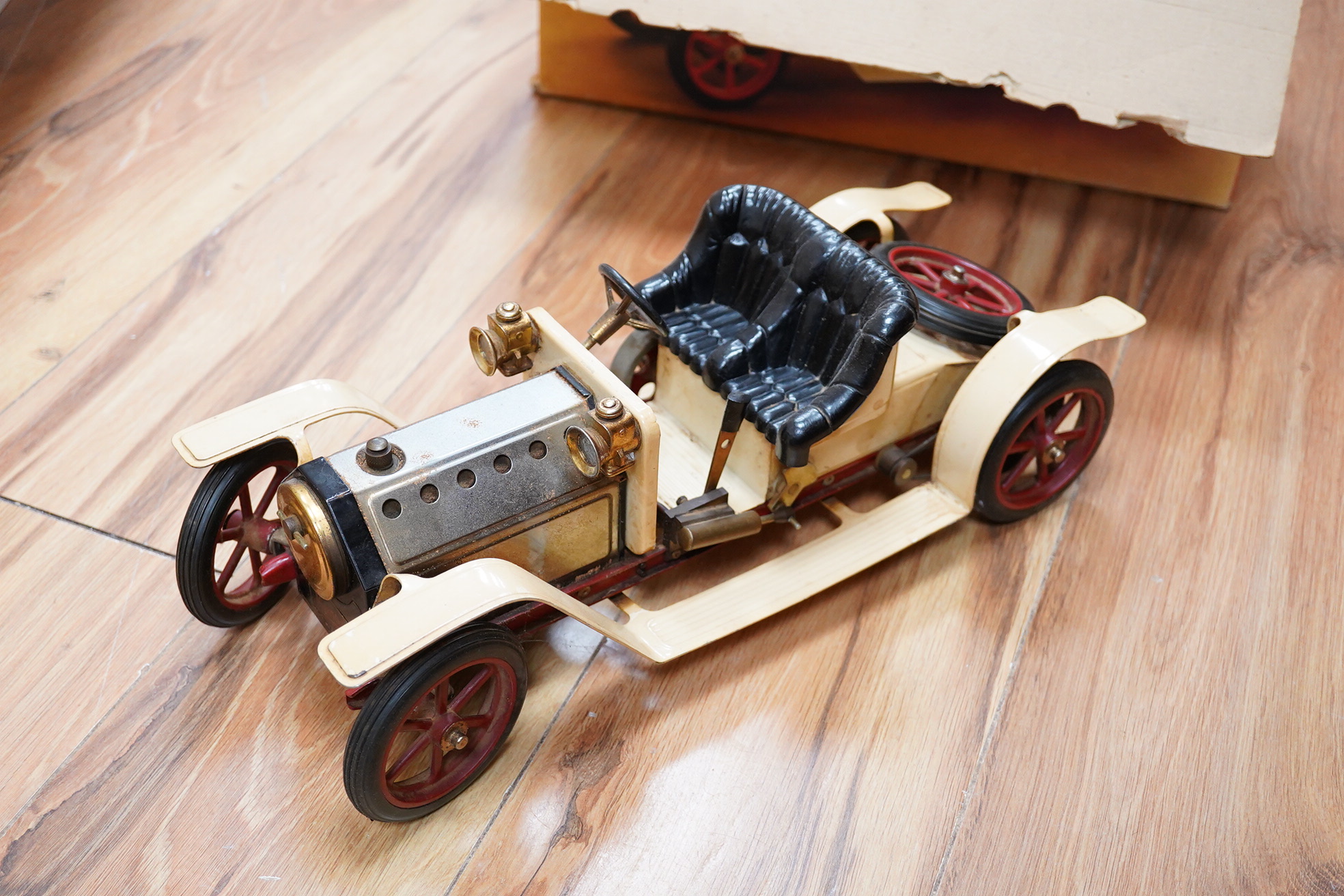 A boxed Mamod Steam Roadster, live steam, single cylinder cream painted car, together with some accessories